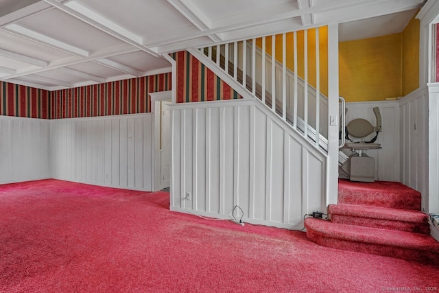 interior space with a wainscoted wall and carpet floors