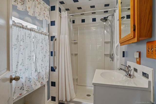 full bathroom featuring a shower stall and vanity