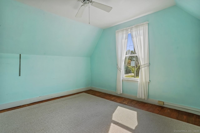 bonus room with ceiling fan, baseboards, vaulted ceiling, and wood finished floors