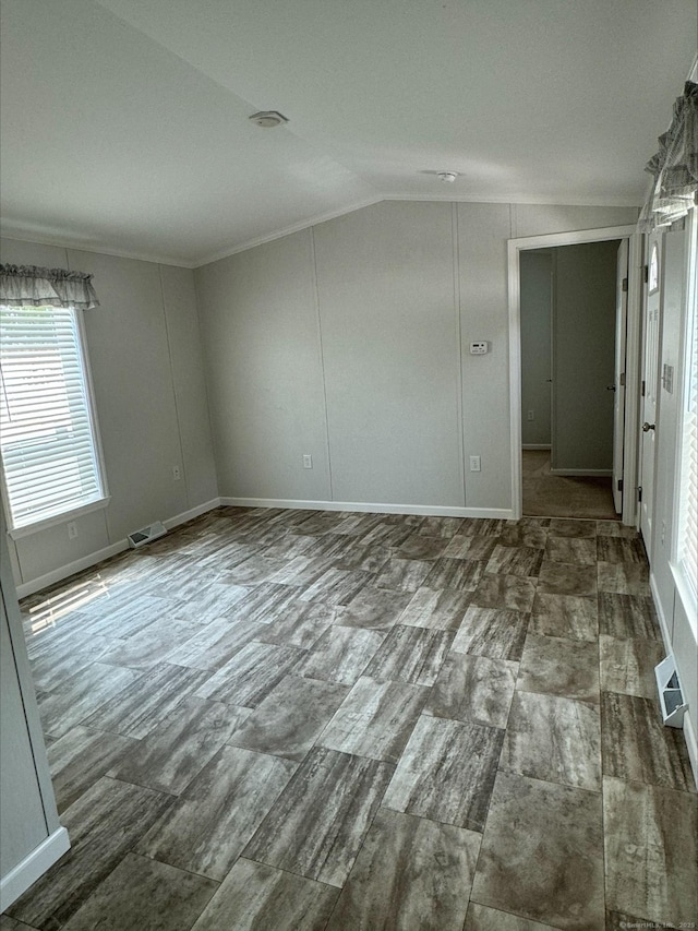 unfurnished room with lofted ceiling