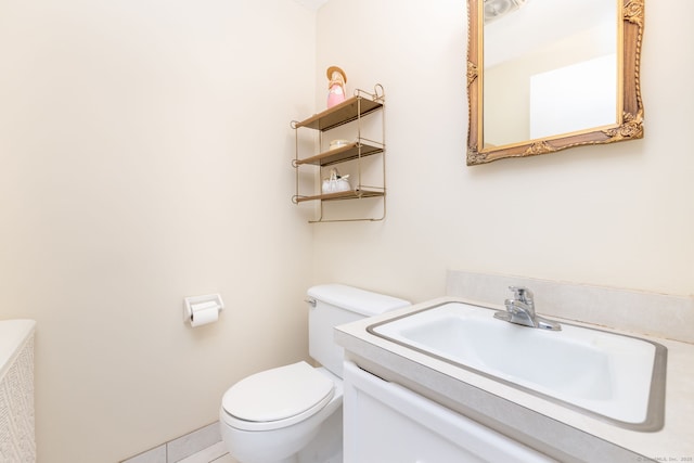 bathroom featuring toilet and vanity