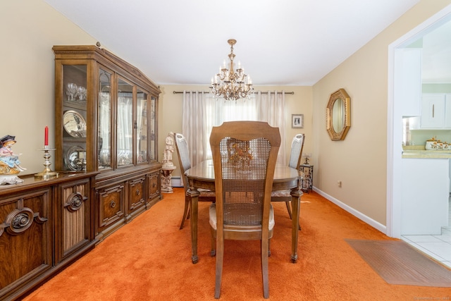 dining area featuring a baseboard radiator, baseboards, a chandelier, and light carpet