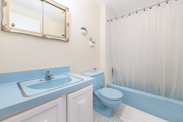 full bath with tile patterned floors, vanity, toilet, and shower / bath combo with shower curtain