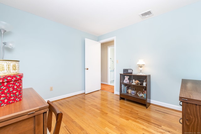 office space featuring visible vents, baseboards, and light wood-style floors