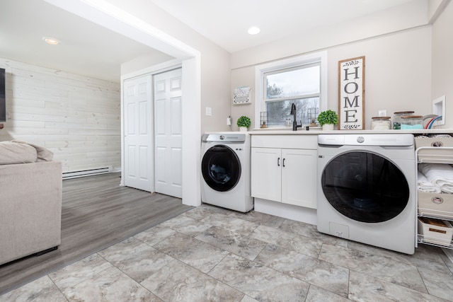 laundry room featuring recessed lighting, cabinet space, a sink, and wooden walls