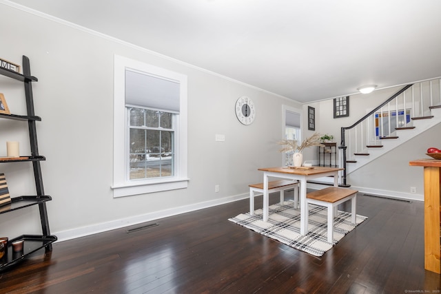 dining space with wood-type flooring, visible vents, baseboards, and a healthy amount of sunlight