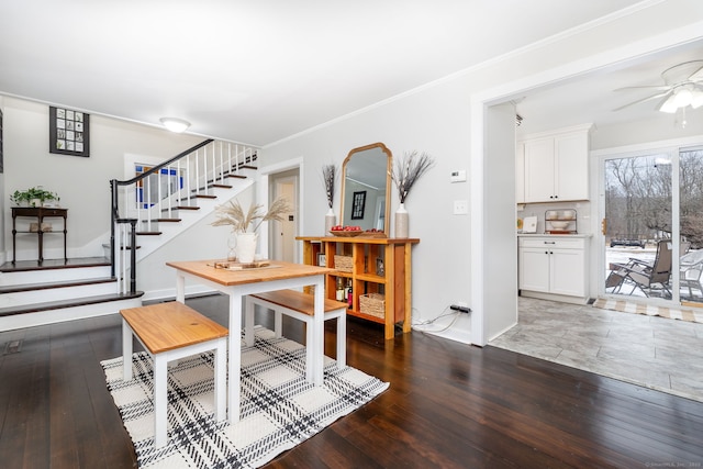 dining space with hardwood / wood-style flooring, stairs, a ceiling fan, and crown molding