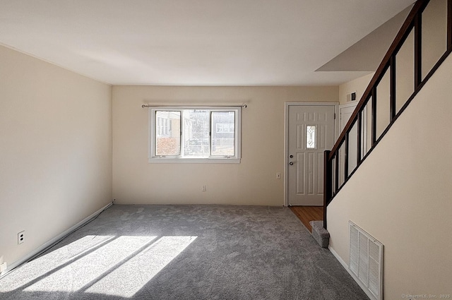 carpeted entryway featuring stairs and visible vents