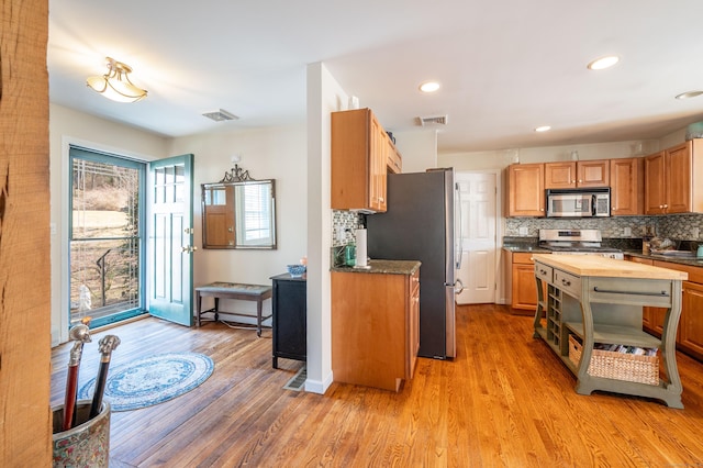 kitchen featuring light wood-style flooring, visible vents, appliances with stainless steel finishes, and butcher block counters