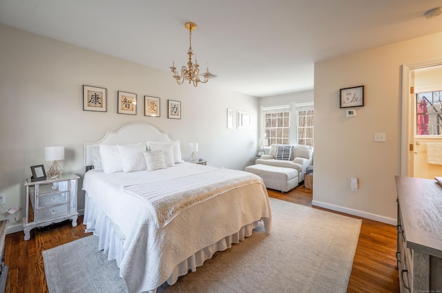 bedroom featuring a chandelier, baseboards, and dark wood-style floors