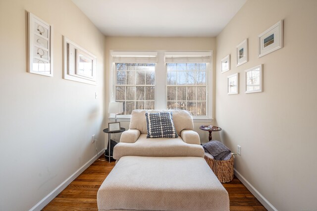 sitting room featuring baseboards and wood finished floors