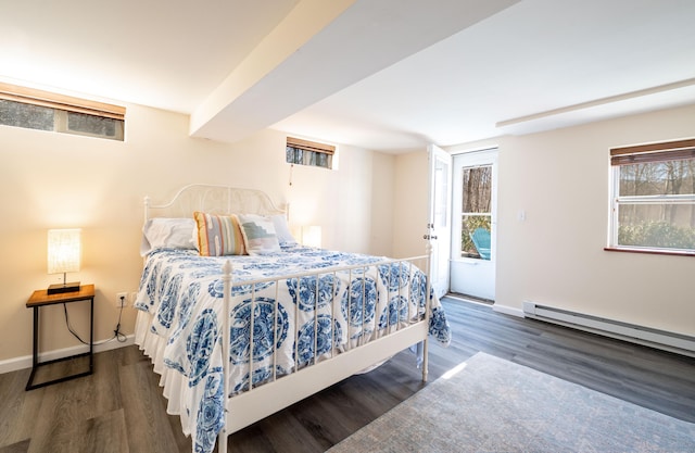 bedroom featuring access to outside, a baseboard heating unit, baseboards, and wood finished floors