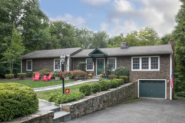 ranch-style house featuring aphalt driveway, a garage, and a chimney