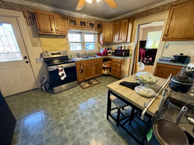 kitchen featuring brown cabinetry, electric stove, light countertops, crown molding, and backsplash