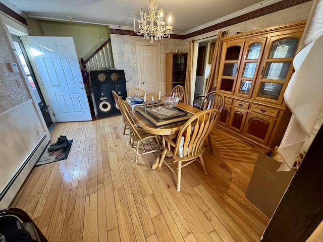 dining room featuring wallpapered walls, ornamental molding, light wood-style floors, a baseboard heating unit, and a notable chandelier