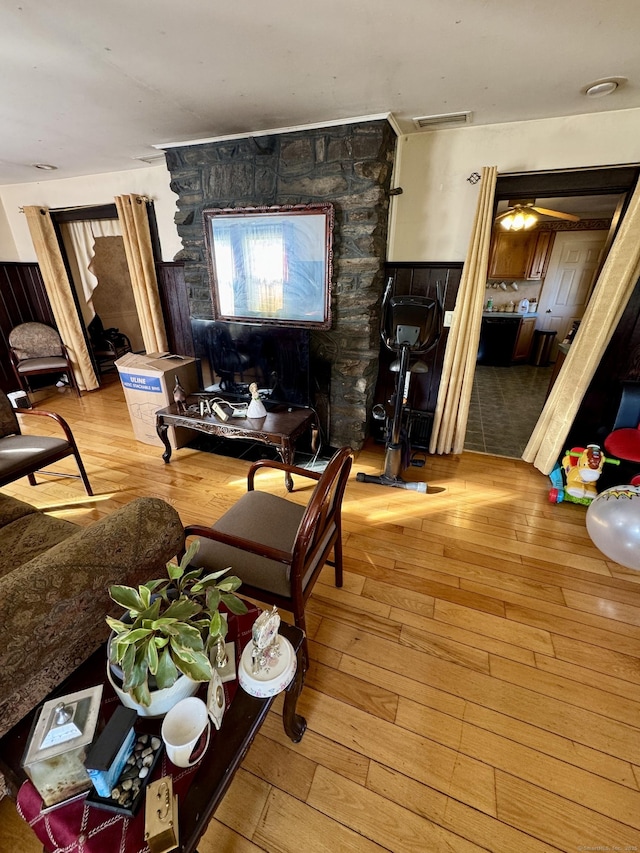 living room featuring wood-type flooring and visible vents