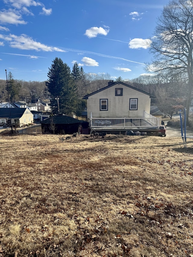 view of home's exterior with a wooden deck