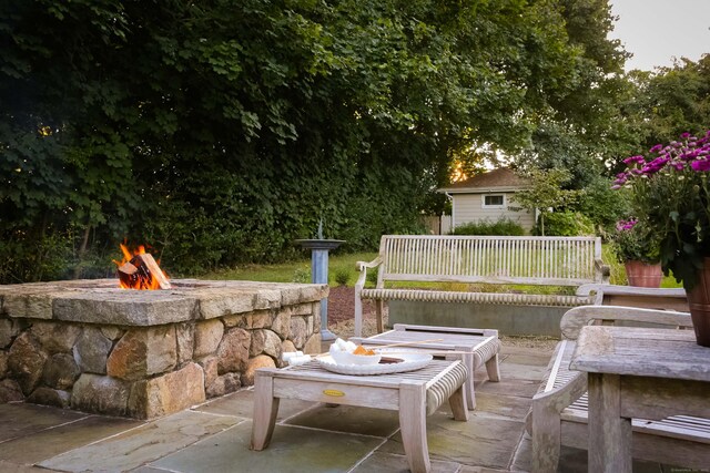 view of patio with fence and a fire pit