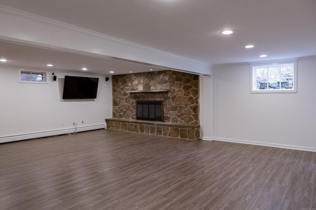 9 Schiller Rd, Fairfield, CT 06825 - basement featuring dark wood-style floors, baseboards, a baseboard radiator, recessed lighting, and a stone fireplace