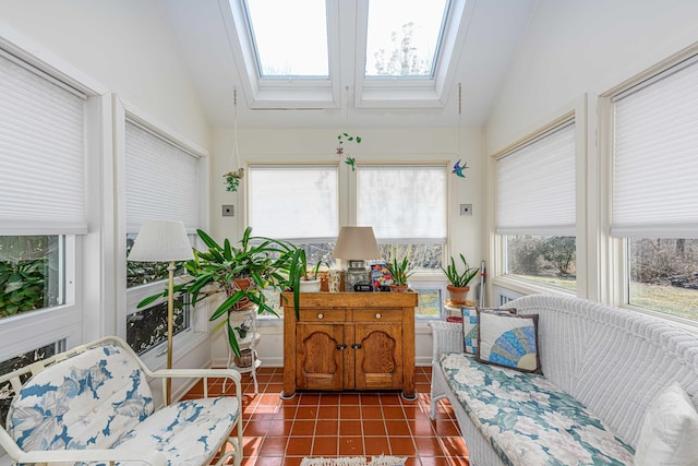 sunroom featuring lofted ceiling with skylight