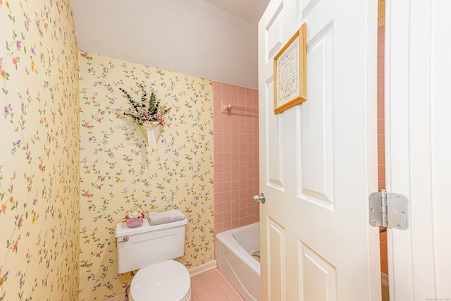 bathroom with toilet, baseboards,  shower combination, tile patterned floors, and wallpapered walls