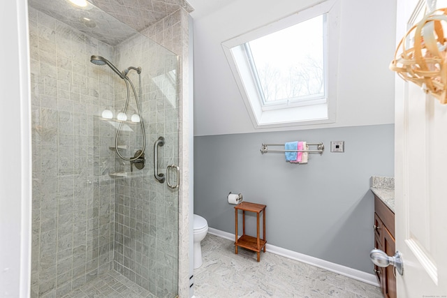 full bathroom with toilet, lofted ceiling with skylight, a stall shower, vanity, and baseboards