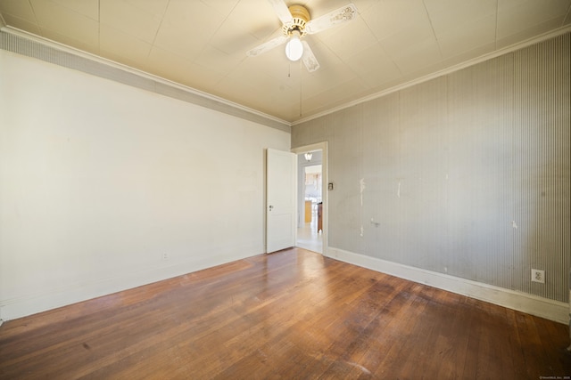 spare room featuring ornamental molding, ceiling fan, baseboards, and hardwood / wood-style flooring