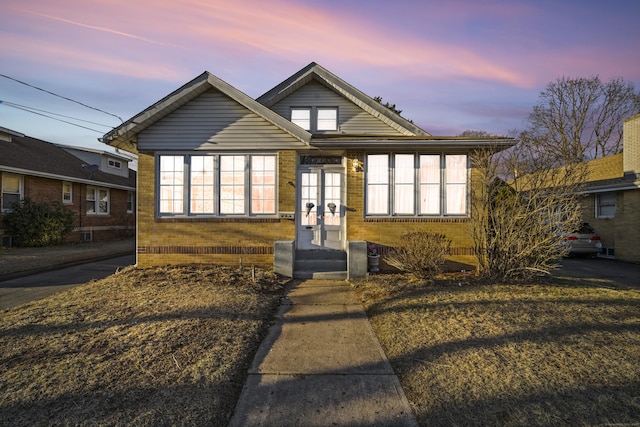 bungalow with french doors and brick siding