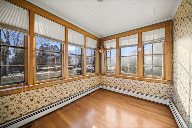 unfurnished sunroom featuring baseboard heating