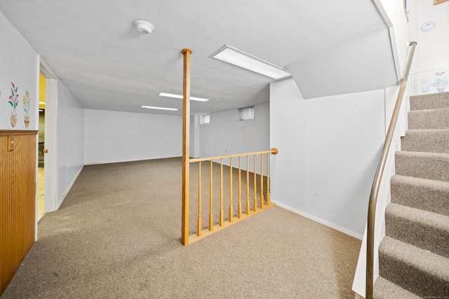 finished basement featuring carpet and stairway