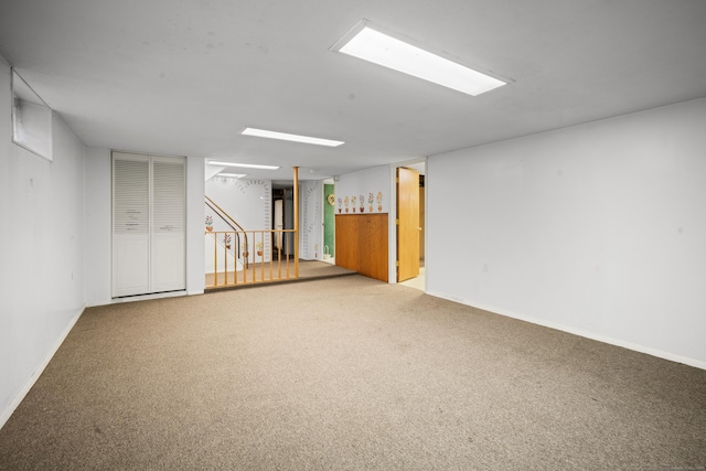 finished basement with carpet, stairway, and baseboards