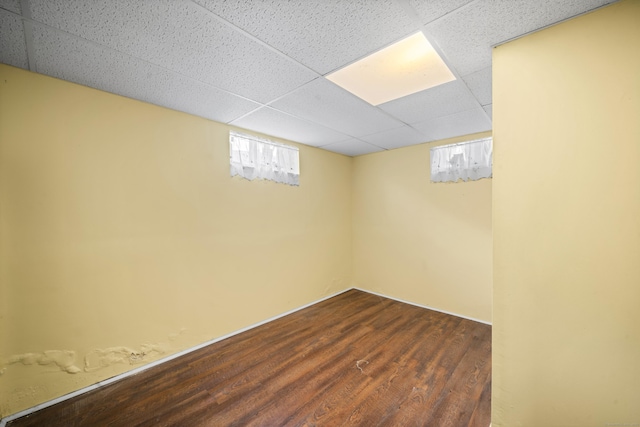 basement with dark wood-style floors and a drop ceiling