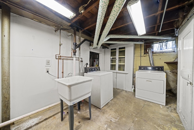 below grade area with a sink and separate washer and dryer