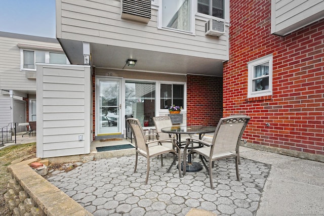 view of patio / terrace with outdoor dining area and cooling unit