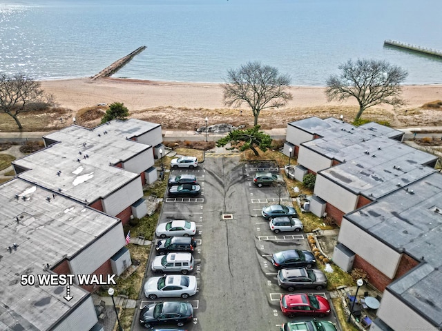 drone / aerial view with a water view and a view of the beach