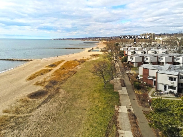 bird's eye view with a water view and a beach view