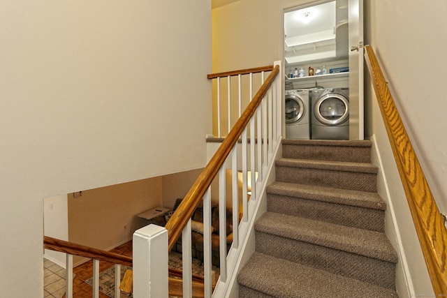 stairs featuring tile patterned floors and washing machine and clothes dryer