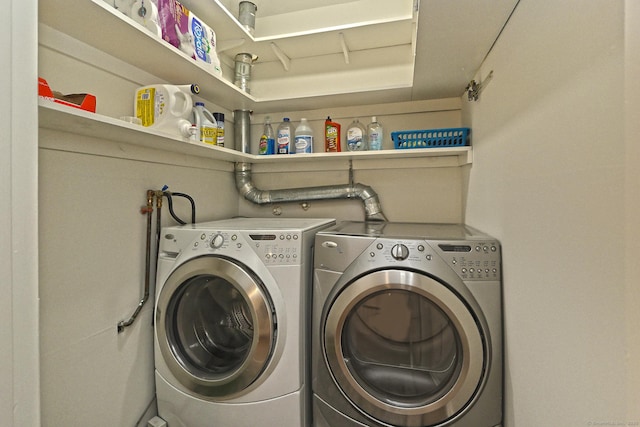 washroom featuring laundry area and separate washer and dryer