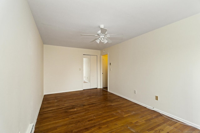 empty room featuring wood finished floors, a ceiling fan, and baseboards