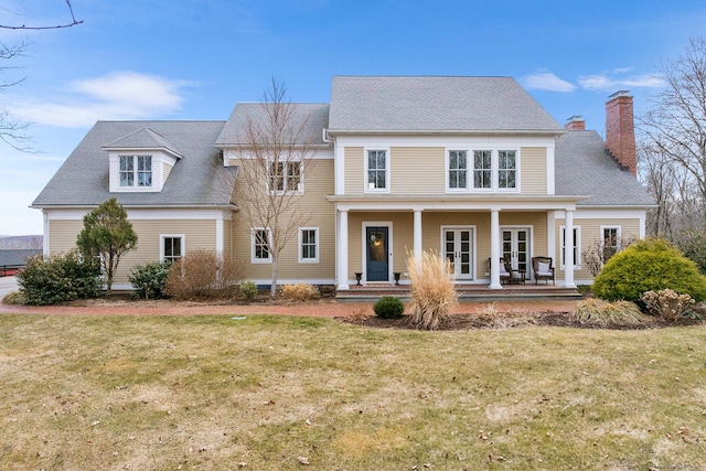 view of front of home with french doors and a front lawn