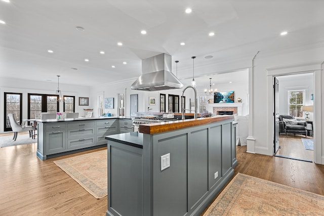 31 Birch Hill Rd, Lyme, CT 06371 - kitchen featuring gray cabinets, island range hood, a chandelier, crown molding, and a large island with sink