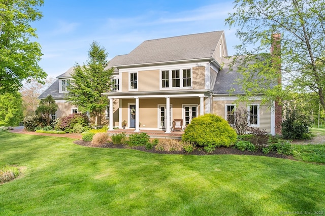 31 Birch Hill Rd, Lyme, CT 06371 - rear view of property featuring a porch, a lawn, and a chimney
