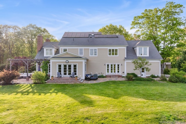 31 Birch Hill Rd, Lyme, CT 06371 - back of house with french doors, a pergola, a patio area, a lawn, and a chimney