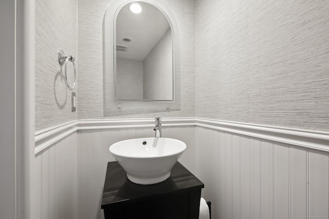 bathroom featuring wainscoting, visible vents, and vanity