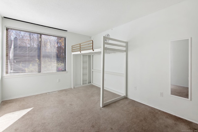 unfurnished bedroom with carpet floors and a closet