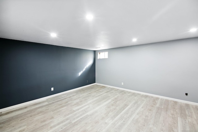 spare room with recessed lighting, light wood-style flooring, and baseboards