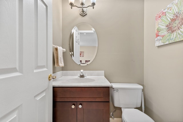 bathroom with toilet and vanity