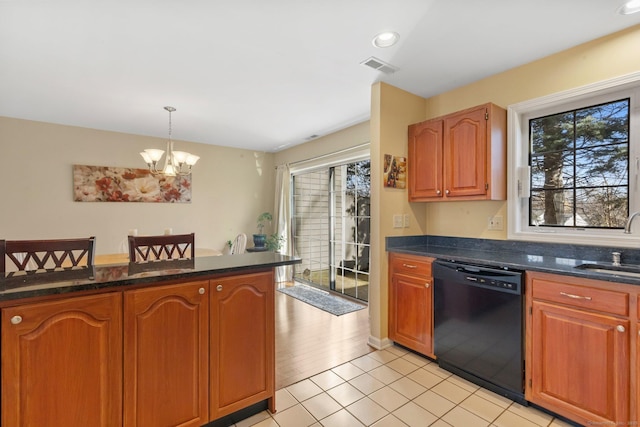 kitchen with decorative light fixtures, visible vents, plenty of natural light, and black dishwasher