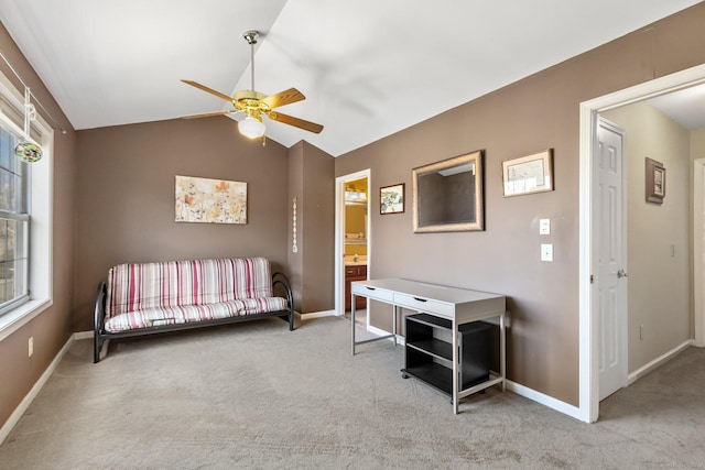 interior space featuring carpet flooring, baseboards, ceiling fan, and vaulted ceiling