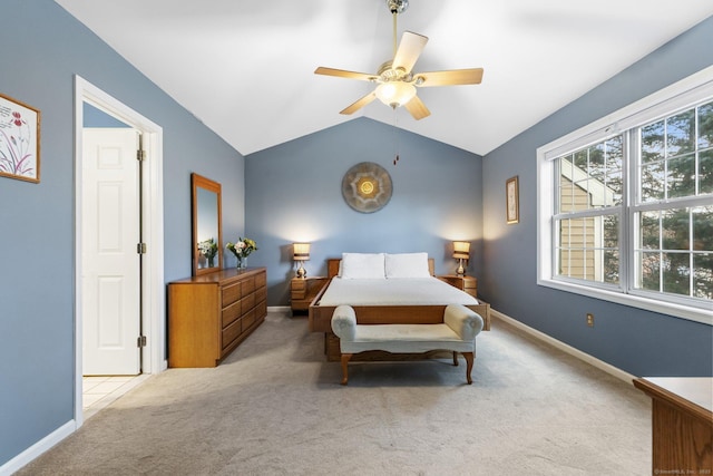 bedroom with carpet flooring, ceiling fan, baseboards, and vaulted ceiling